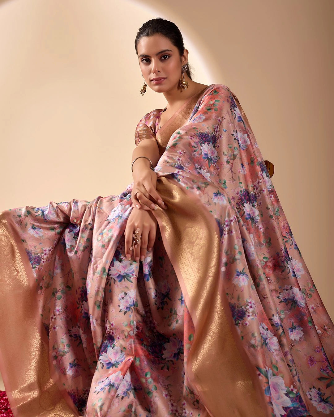 Soft pink lichi silk saree featuring a vibrant floral digital print, an elegant gold zari woven border, and tassel details by Kalyanja.